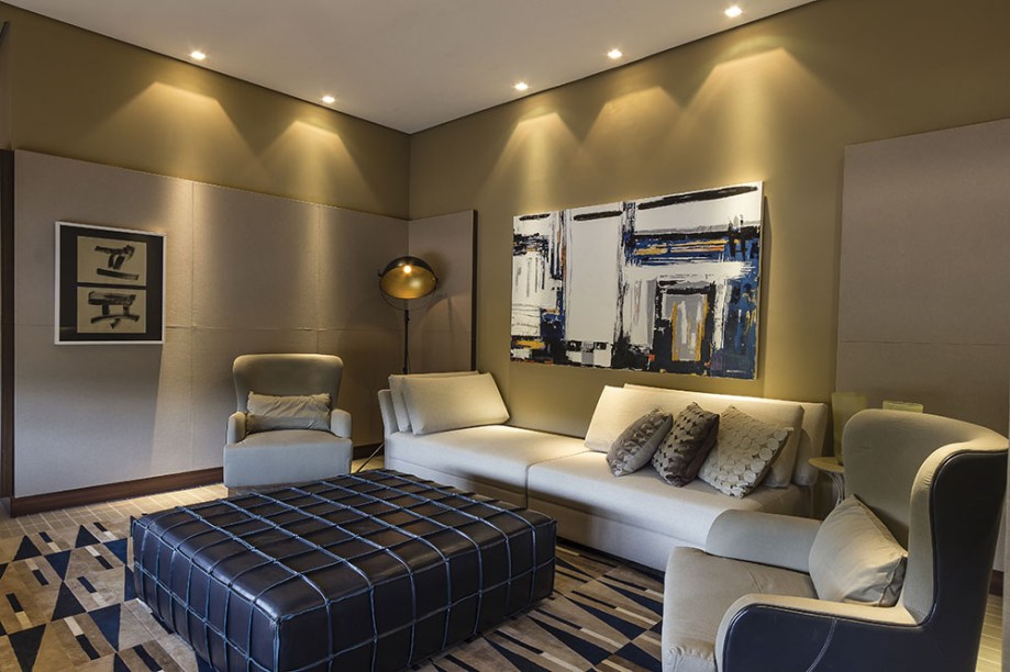 <span>Sala da Família - Aldomar Caprini. A distribuição do layout evidencia o aconchego e favorece a realização de várias atividades em grupo, como assistir TV, ler livros e revistas. Nas paredes são intercalados revestimentos como tecido e o tijolinho da Gail. Destaque para o pufe, que pode servir de assento ou como mesa de centro.</span>