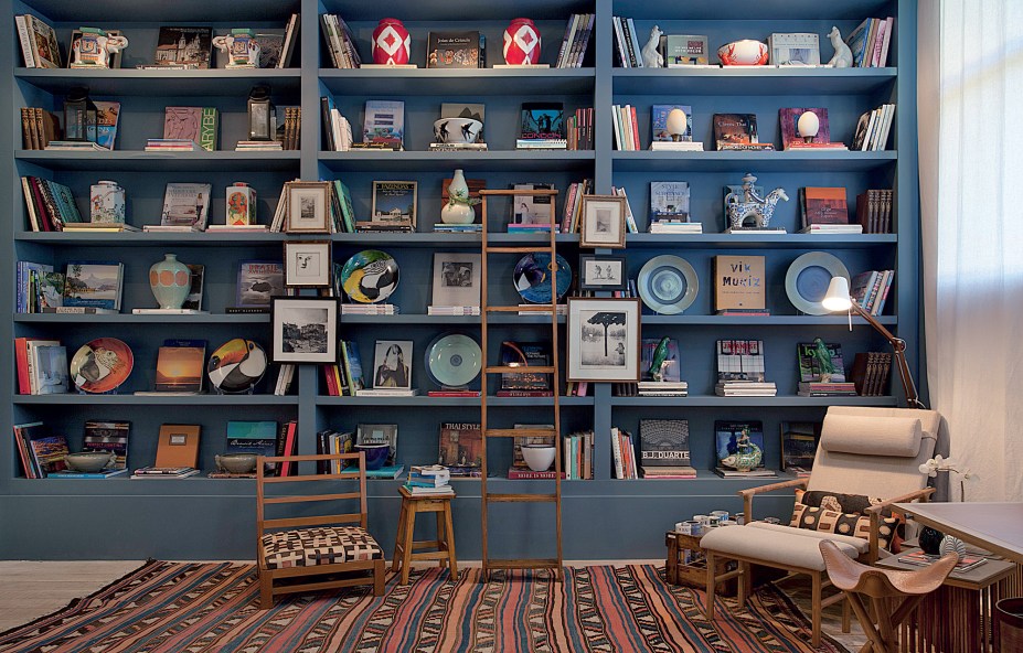 Reforçado pelo tom de azul da Coral das paredes e pela generosa estante de livros na mesma cor, o conforto é prioridade. O ambiente é multiúso e pensado para longas permanências.No mobiliário, peças vindas do interior da França encontram itens de design contemporâneo. CASACOR São Paulo 2016-Estúdio do Casal - Clarisse Reade, Adriana Pereira e Carolina Reade.