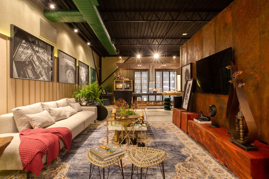 Loft - Artur Moraes, Joana Moraes e Miralba Moraes. Lofts são espaços sem divisórias, onde sutilezas demarcam cada ambiente. É o que se encontra neste projeto de 117 m² inspirado na sustentabilidade, que reaproveita materiais garimpados em um ferro velho. Uma parede foi produzida em chapa de ferro e isola o quarto da sala, garantindo privacidade. Nela, um stain fosco foi aplicado para que a ferrugem não avance. Ao fundo, na cozinha, a bancada F53 da Florense tem mais de 4 metros de extensão.