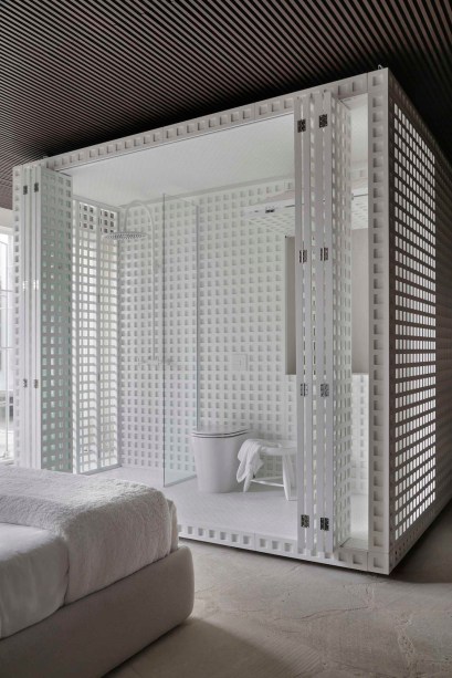 Nildo José - Casa Dendê. O módulo central totalmente envelopado pelas treliças concentrou a área da cozinha e da sala de banho em lados opostos. A luz entra totalmente no espaço, que pode ser isolado quando as portas camarão estão fechadas. A solução chamou a atenção na CASACOR São Paulo.
